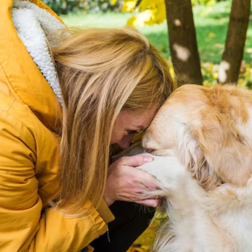 lady holds the paw of dog Blast Auxiliary Premium HEPA Air Cleaner